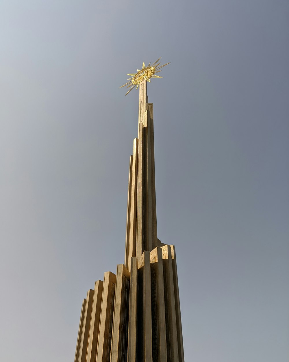 a very tall building with a cross on top of it