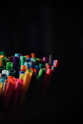 A vibrant array of colorful markers neatly arranged in a fan shape on a wooden table.