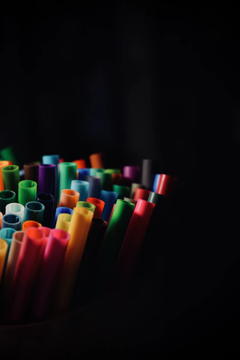 A vibrant array of colorful markers neatly arranged in a fan shape on a wooden table.
