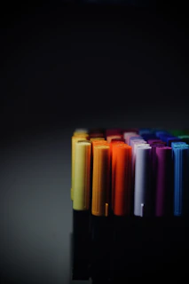 a row of multicolored crayons sitting on a table