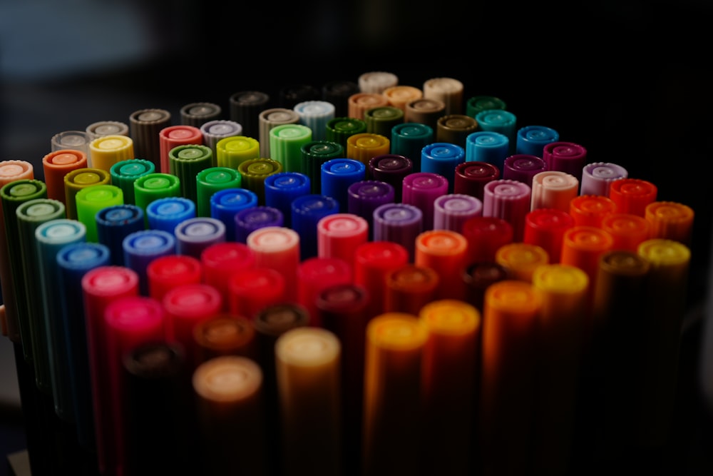 a close up of many different colored crayons
