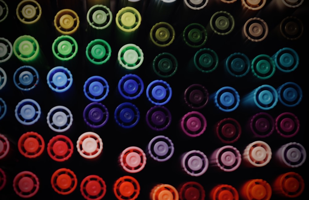 a group of multicolored bottles sitting next to each other