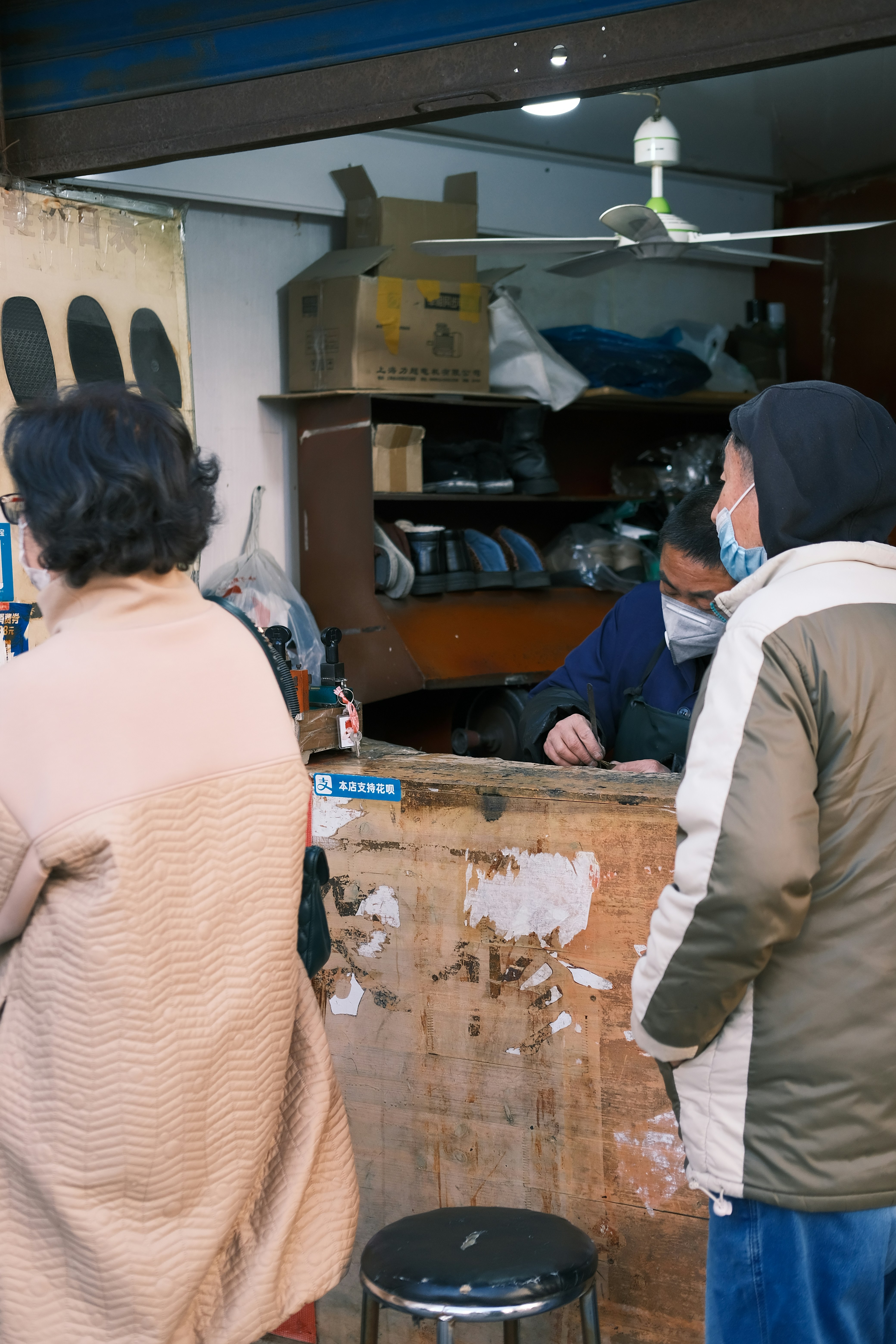 A man is working in the shoe repair shop