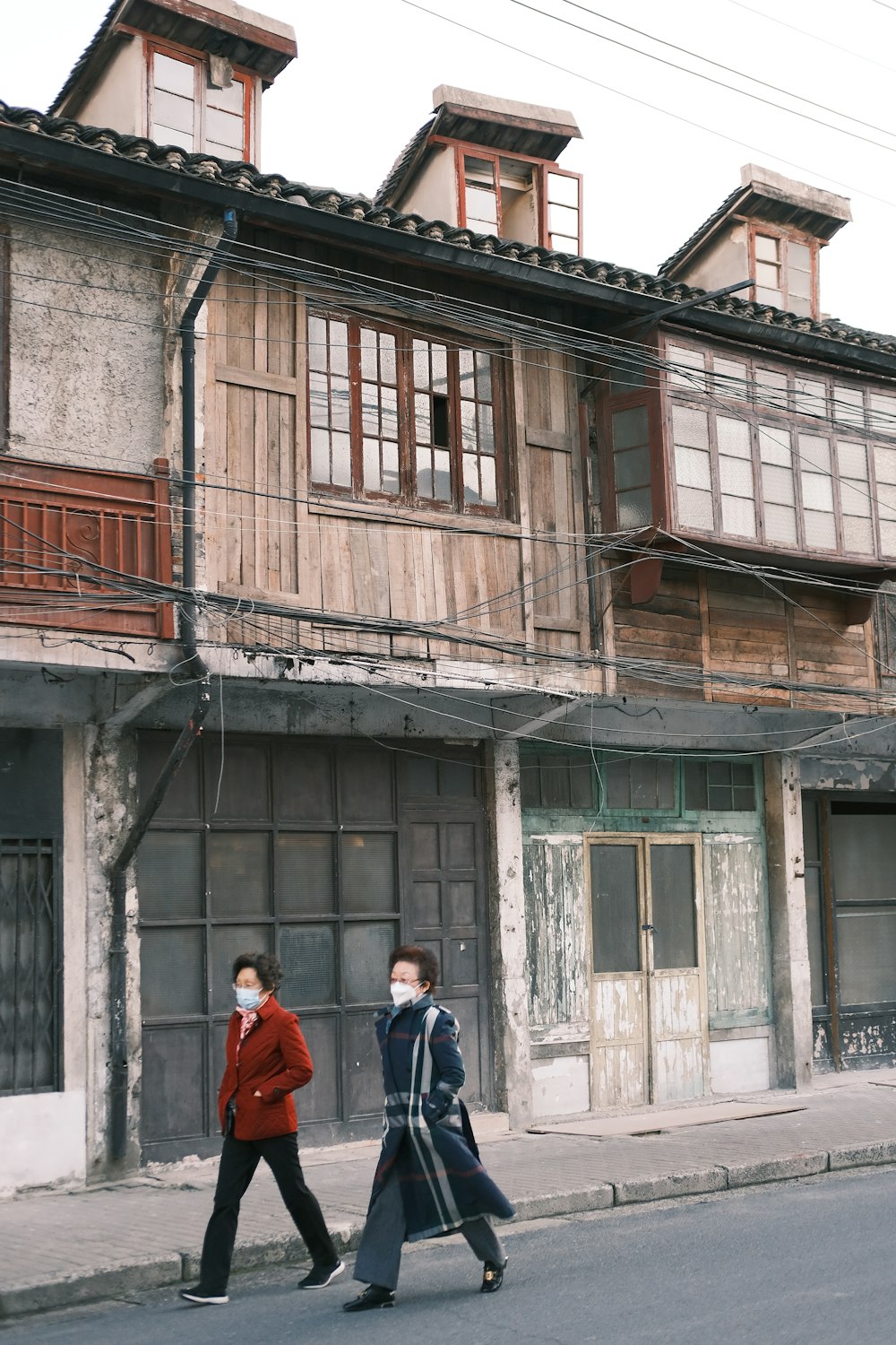 a couple of people walking down a street