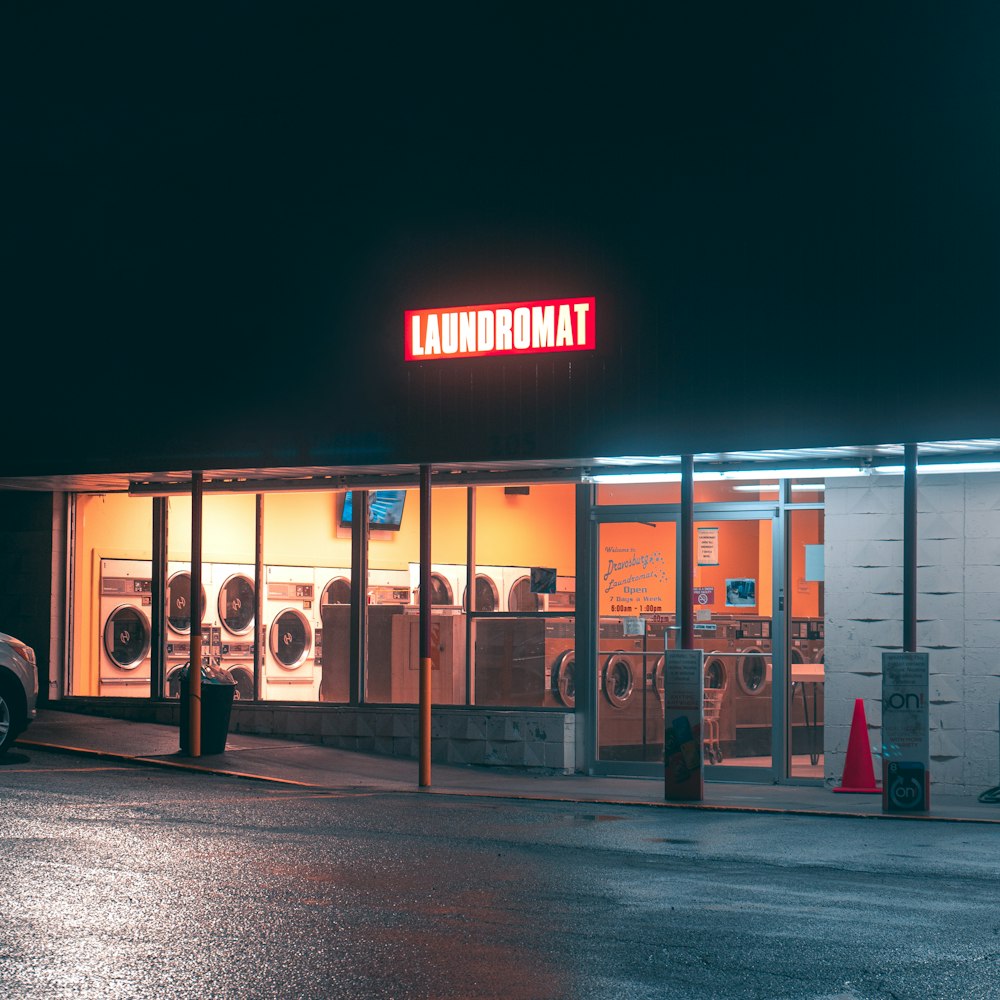 a store front with a neon sign above it