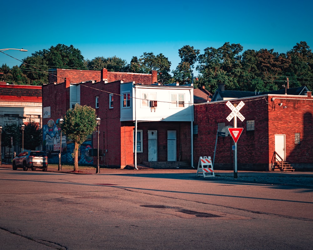 a red brick building with a street sign in front of it