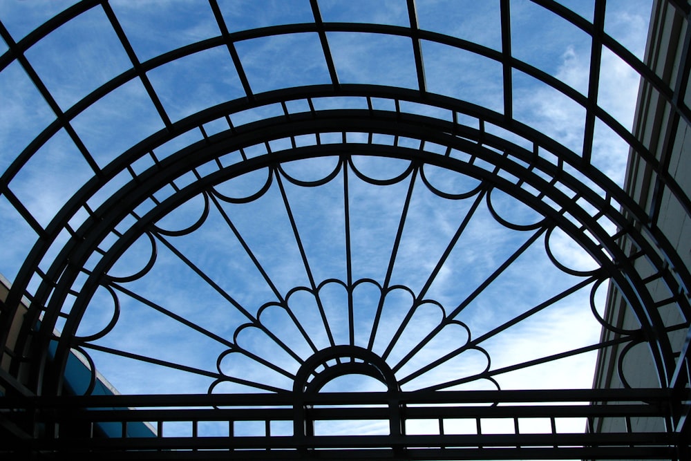 a metal gate with a sky in the background