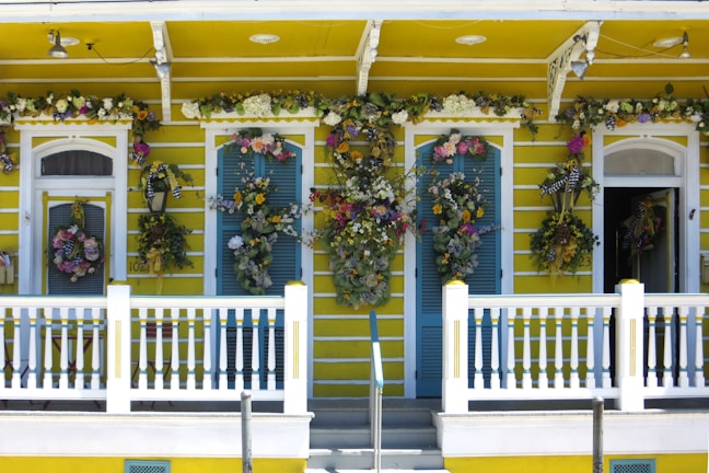 A freshly painted front porch with crisp white trim and warm yellow walls.