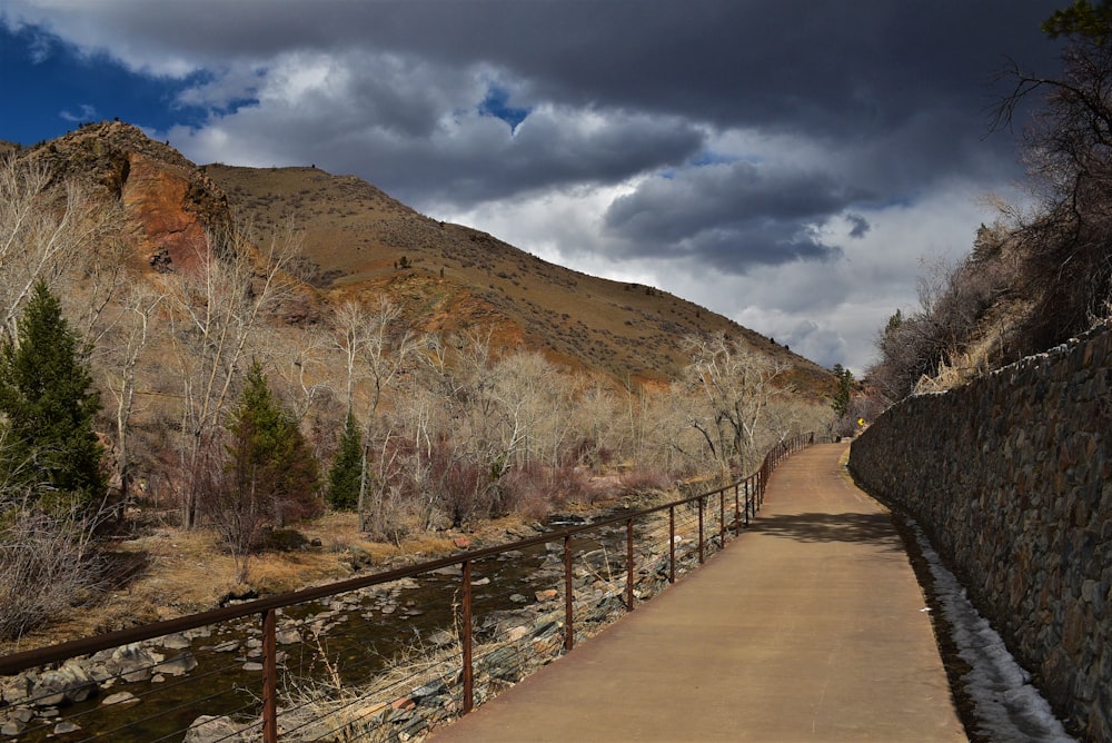 a path that is next to a mountain