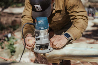 a man using a driller on a piece of wood