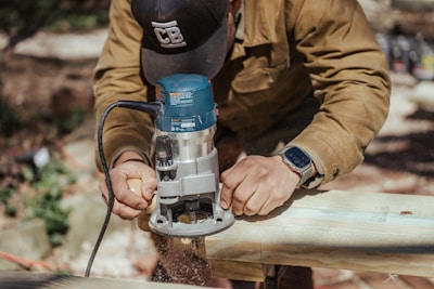 A worker using a power tool on a job site.
