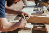 a man working on a piece of wood