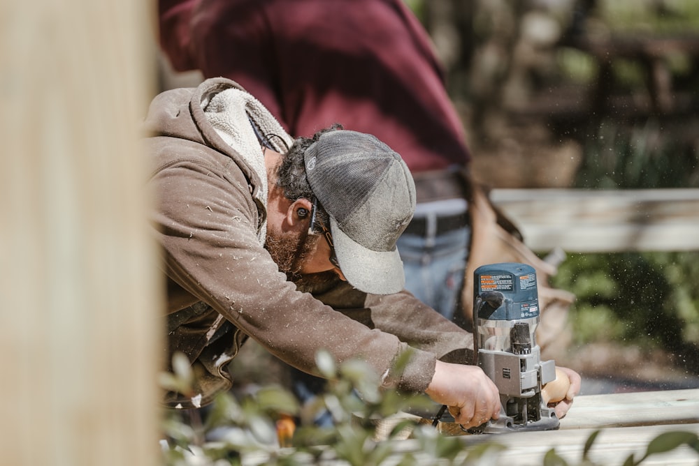 a man using a driller on a piece of wood