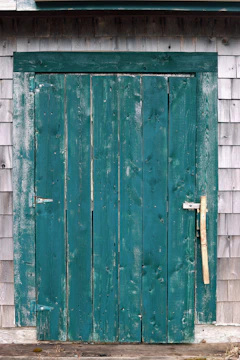 Close-up of a freshly painted teal door with clean edges and a matte finish.