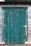 Close-up of a freshly painted front door in a rich teal shade, showcasing smooth, even brush strokes.