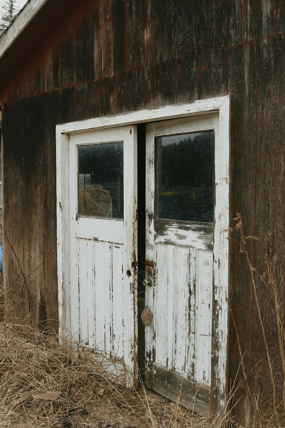 an old barn with two doors and a window