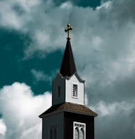 a church steeple with a cross on top