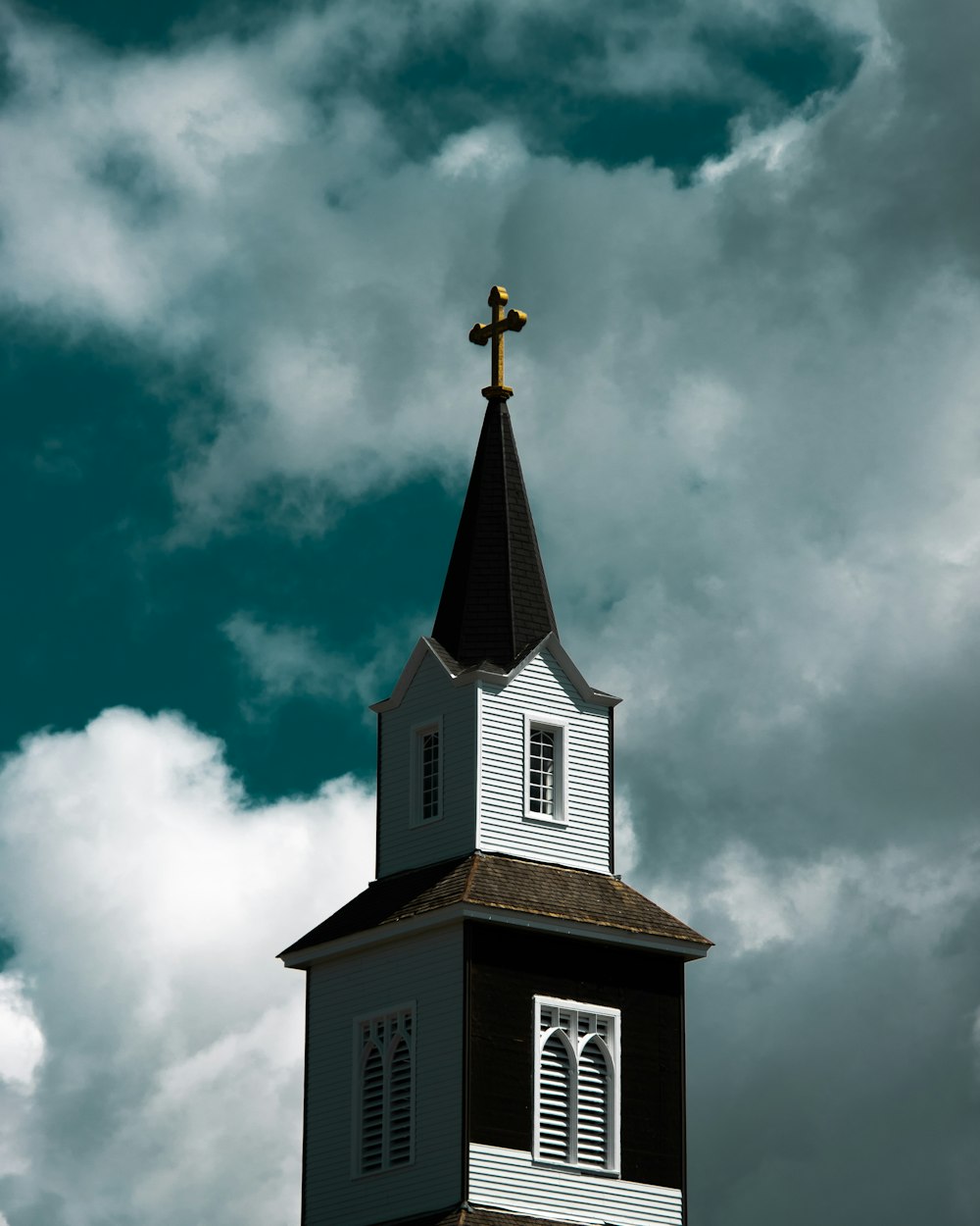 a church steeple with a cross on top