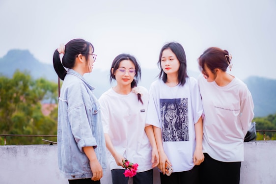 A diverse group of women wearing stylish jeans in a casual outdoor setting.