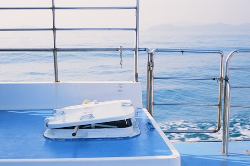 Weatherproof 3D printed hatch latch installed on a white sailboat hull glistening under Greek sun