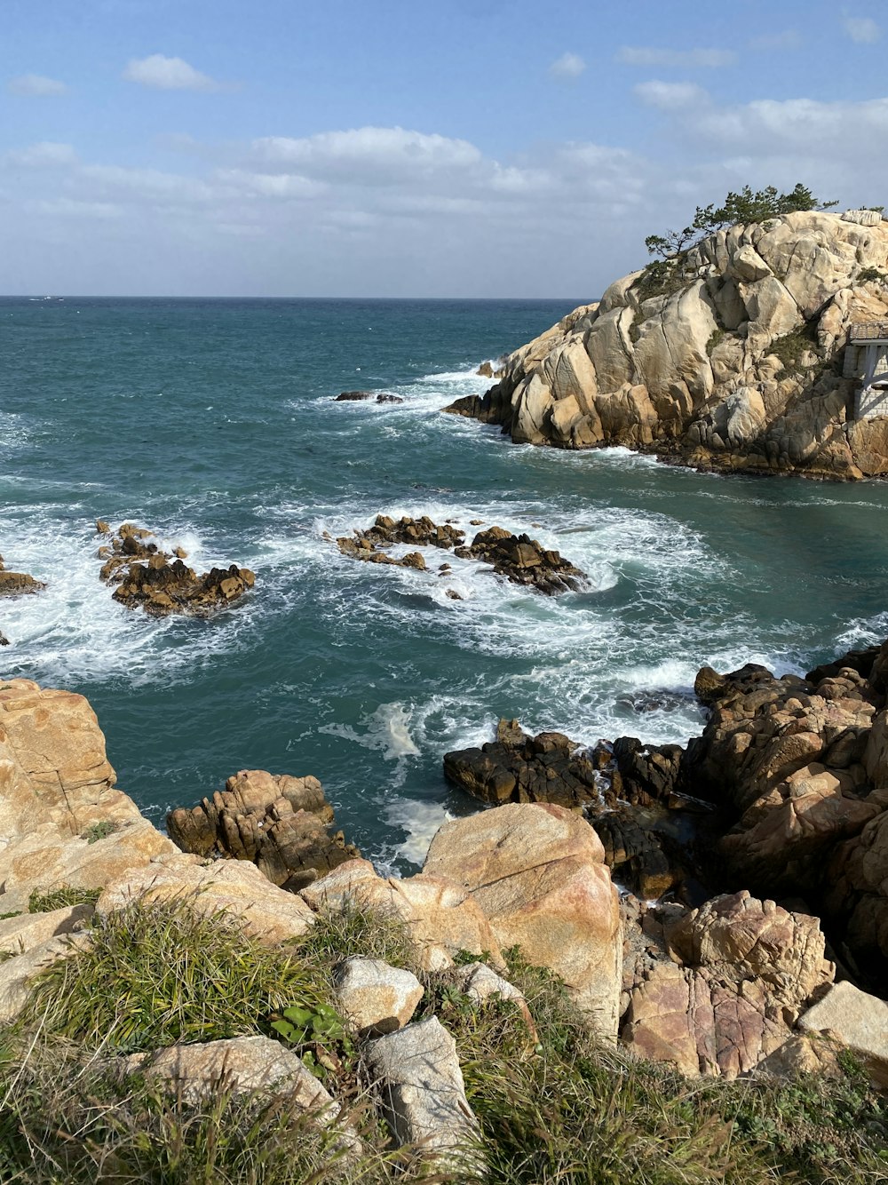 a large body of water sitting next to a rocky shore