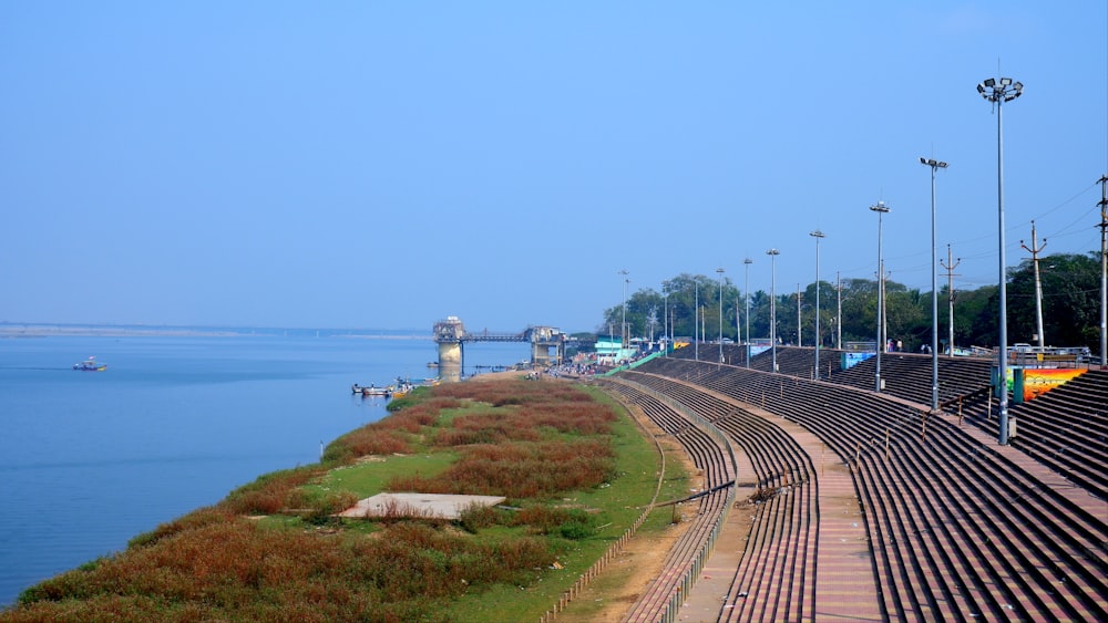 a train track next to a body of water