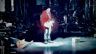 A safety inspector examining a light fixture with a flashlight in a dimly lit indoor space.