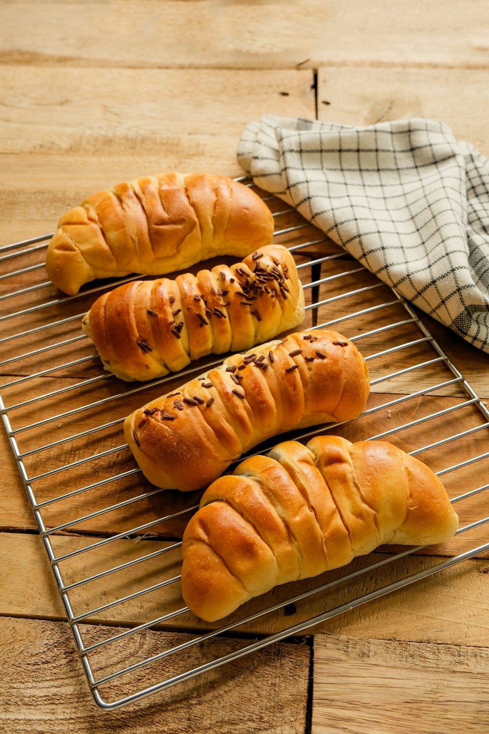 three long loafs of bread sitting on a cooling rack
