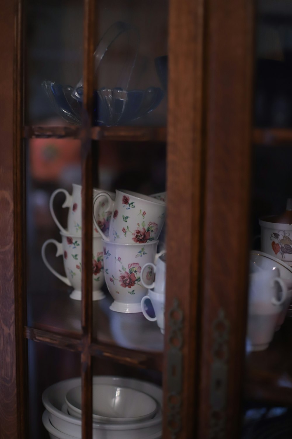 a cabinet filled with lots of white cups and saucers