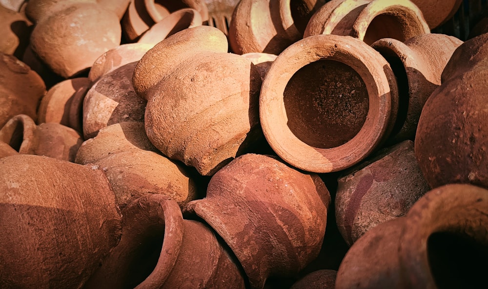 a pile of clay pots sitting next to each other