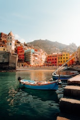 a small boat in the water next to a city