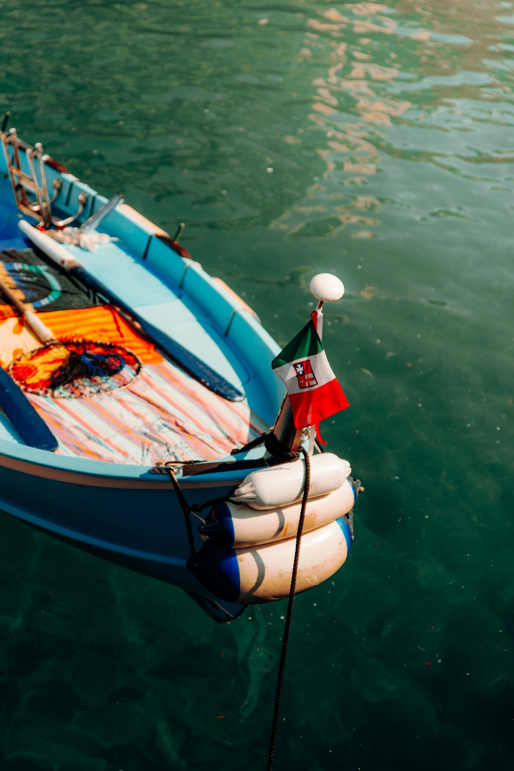 a small boat tied to a dock in the water