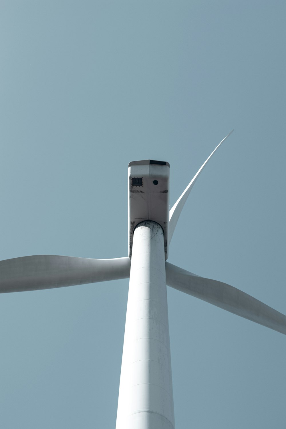 a close up of a wind turbine on a clear day