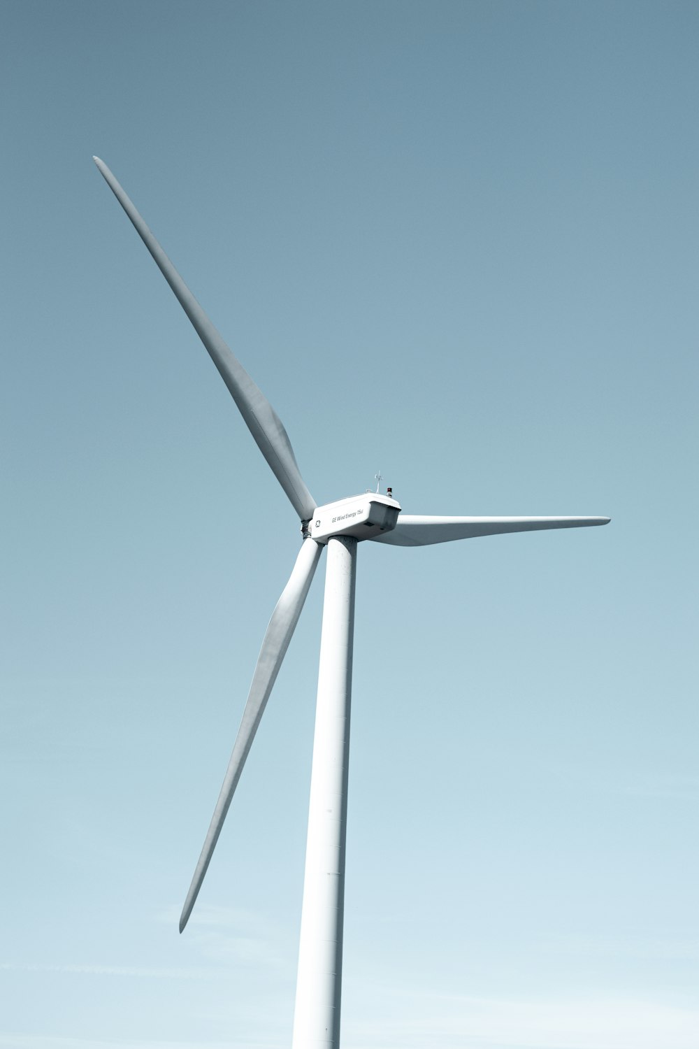 a wind turbine is shown against a blue sky