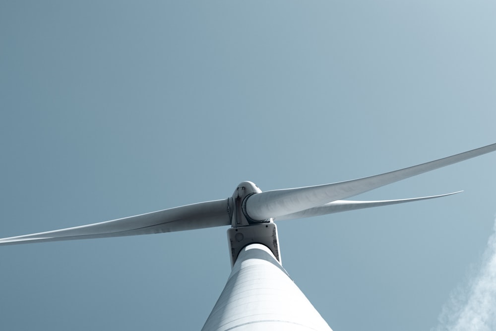 a close up of a wind turbine against a blue sky