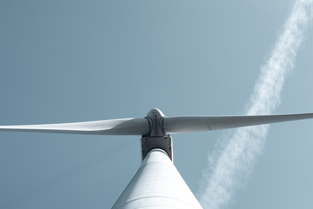 a close up of a wind turbine against a blue sky