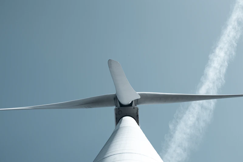 Close view of a single wind turbine blade against an open sky