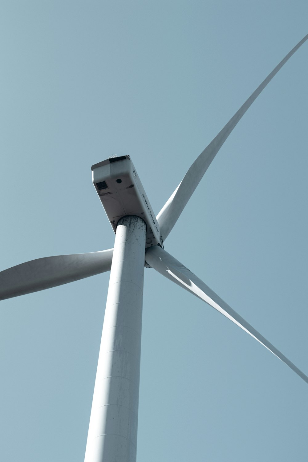 a close up of a wind turbine on a clear day