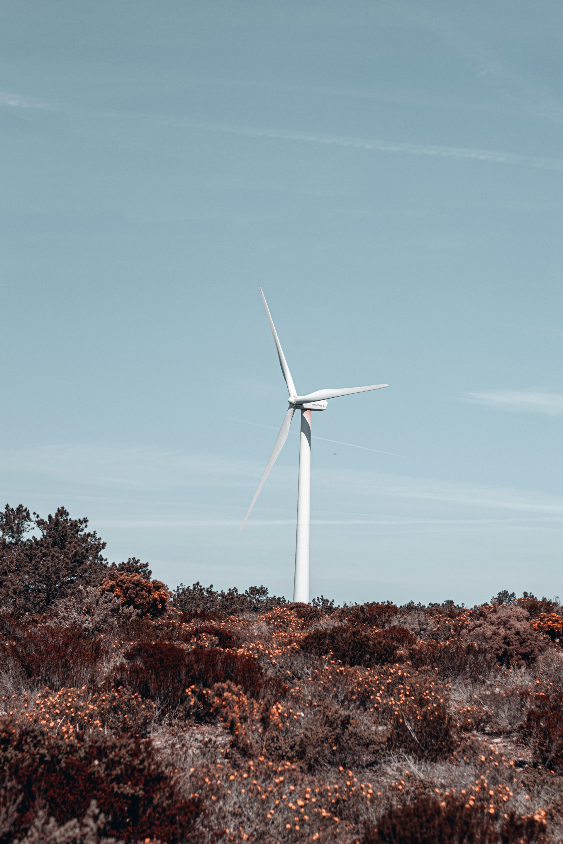 a wind turbine on top of a hill