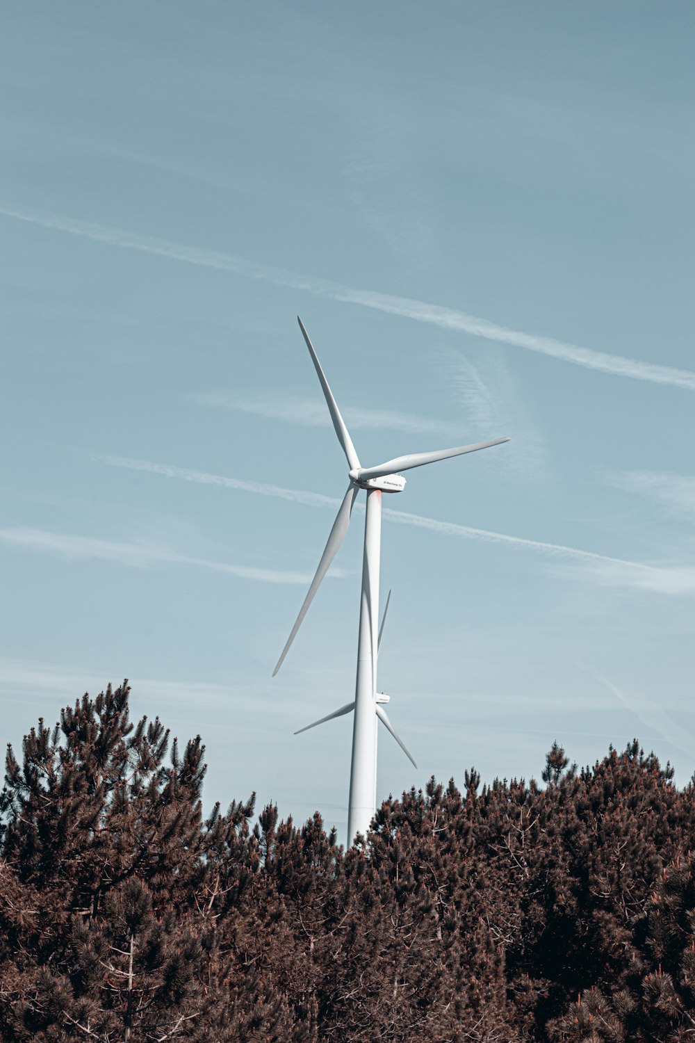 a wind turbine on top of a hill