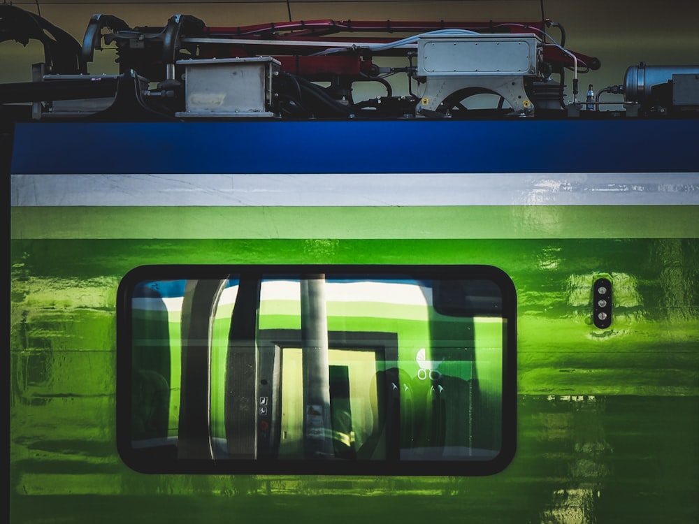 a close up of a train with a reflection of it