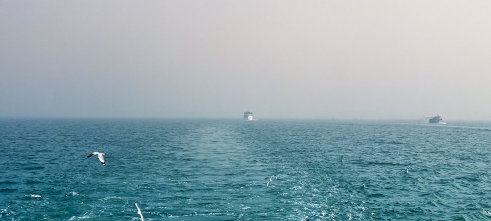 a large body of water with a boat in the distance