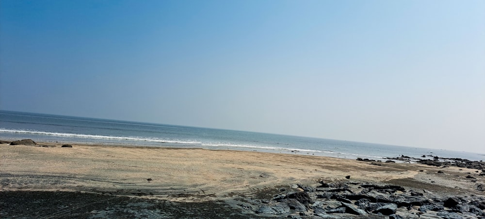 a person riding a surfboard on top of a sandy beach