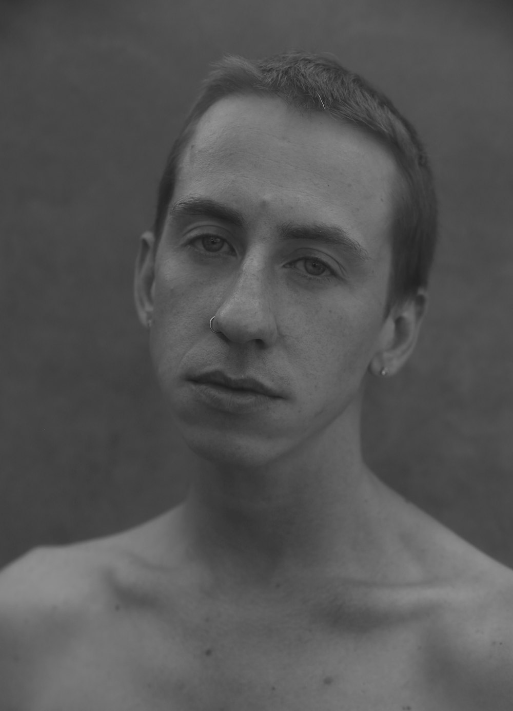 a black and white photo of a shirtless man