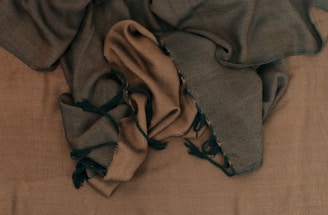 a pile of cloth sitting on top of a bed