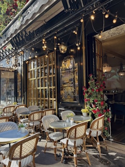 a restaurant with tables and chairs outside of it