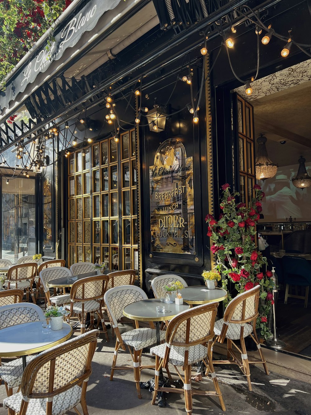 a restaurant with tables and chairs outside of it