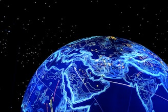 A glowing blue digital representation of the Earth is depicted, highlighting continents with illuminated contour lines against a black starry background. Small lights appear scattered across the surface, resembling cities or data points.