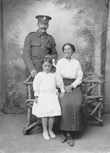 a black and white photo of a man and two women