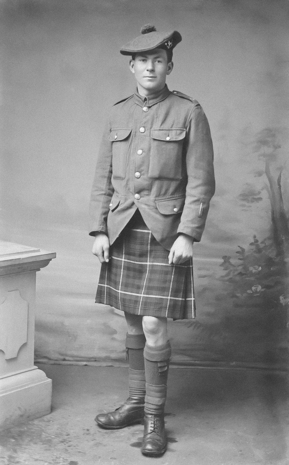 an old photo of a man in a kilt